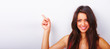 Happy beautiful girl pointing on to white background