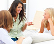 Three young girls sitting at home and having a conversation