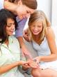 Two happy young women looking at friend's finger ring