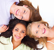 Portrait of happy young friends lying together on white