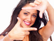 Closeup portrait of a happy young lady gesturing against white