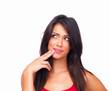 Smiling young woman with finger on cheek isolated on white