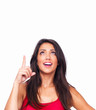 Happy beautiful girl pointing above isolated on white