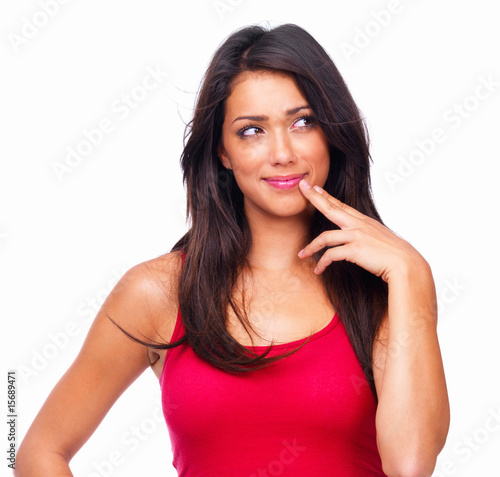 Photo: Young woman with fingers on cheek isolated on white background Young woman with fingers on cheek isolated on white background