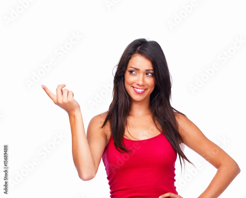 Photo: Happy beautiful girl pointing to side isolated on white Happy beautiful girl pointing to side isolated on white