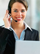 Businesswoman talking on microphone against blur background