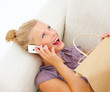 Closeup of a young pretty woman using cellphone