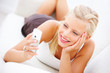 Closeup of a happy blond woman holding a mobile phone