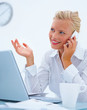 Blond girl with a laptop and using a mobile phone