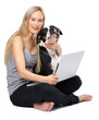 Young woman sitting with pet dog and laptop, portrait