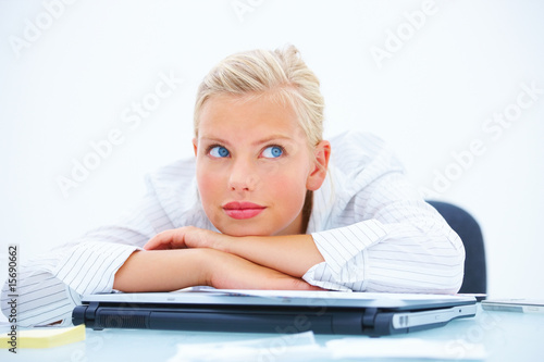 Photo: Beautiful business woman in thoughts at desk Beautiful business woman in thoughts at desk