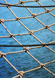 View through the safety net at the blue sea backround View through the safety net at the blue sea backround