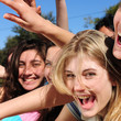 teenage fans screaming and reaching out for a celebrity