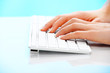 Foto: Human hand typing on a computer keyboard Human hand typing on a computer keyboard