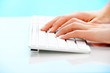 Foto: Human hand typing on a computer keyboard Human hand typing on a computer keyboard