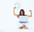 Happy young business woman using laptop
