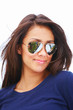Closeup of a woman wearing sunglasses, looking at a side
