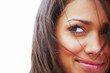 Closeup of a smiling young girl looking away