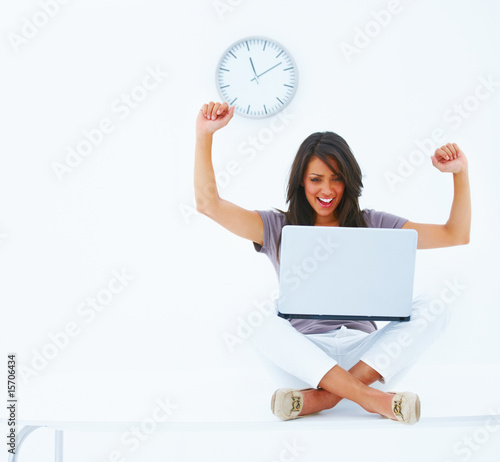 Photo: Happy young business woman using laptop Happy young business woman using laptop