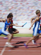 Racers running on track with relay baton