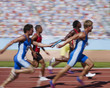 Racers running on track with relay baton
