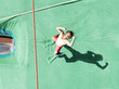 Athlete cheering as he hits the mat after a pole vault