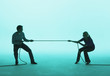 Man and woman playing tug of war