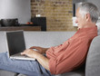 Man sitting on sofa with laptop