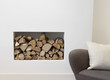 Pile of wood beside chair indoors