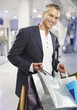 Man with shopping bags in mall