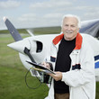 Man standing by a small airplane