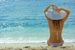 Photo: Brunette girl relaxing on the sea beach Brunette girl relaxing on the sea beach