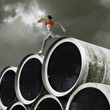 Relay runner with baton going over large cylinders