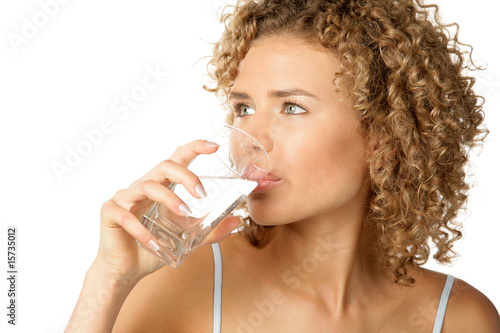 Photo: Portrait of young woman drinking water Portrait of young woman drinking water