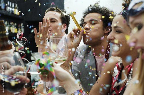 Photo: Friends at a party with confetti Friends at a party with confetti