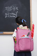 Girl looking at blackboard in classroom