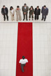 Aerial view of businesspeople and man on red carpet