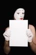 Portrait of  mime with scissors on  black background