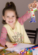 Girl showing her picture that she just cut out