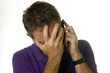 Photo: Man receiving bad news on phone Man receiving bad news on phone
