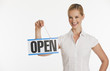 Foto: Small business owner holding up Open sign Small business owner holding up Open sign