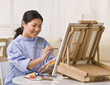 Asian woman painting
