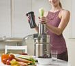 Photo: Attractive woman using juicer Attractive woman using juicer