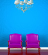 Two chairs  near  blue wall