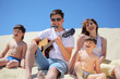 guy in sunglasses plays guitar and  lip accordion  with children