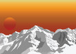 Snow capped mountain range against a dawn or dusk sky