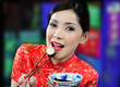 Photo: young asian woman eating sushi young asian woman eating sushi