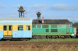 Diesel locomotive and double deck railway car at the depot