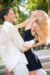 Young happy embracing couple walking together outdoors