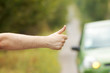 Man hand hitching car on road Man hand hitching car on road